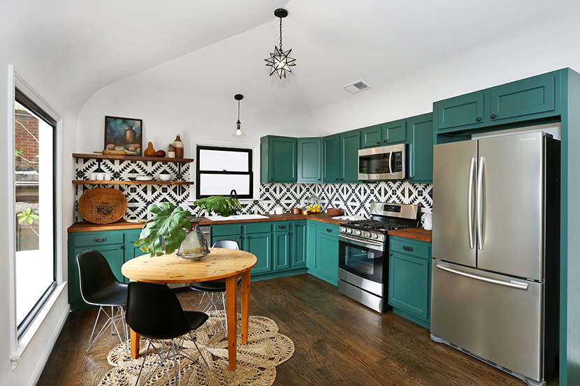 forrest gren painted cabinetry with butcher block countertops stainless steel appliances charming vintage details spanish southwestern style tile backsplash