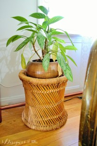 rattan wicker foot stool used as a plant stand