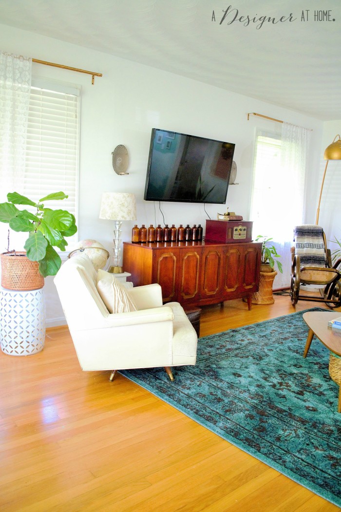 Entering a casually boho eclectic decorated space the living room of a 1950's brick ranch
