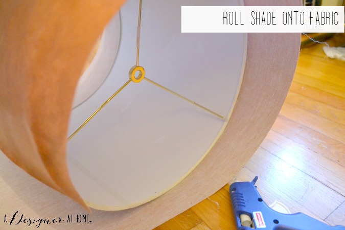roll leather fabric onto shade using hot glue to secure in place