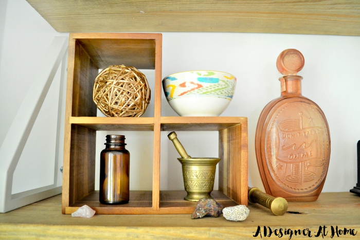 decorating with small items looks bigger when places on an object with cubbies on a shelf