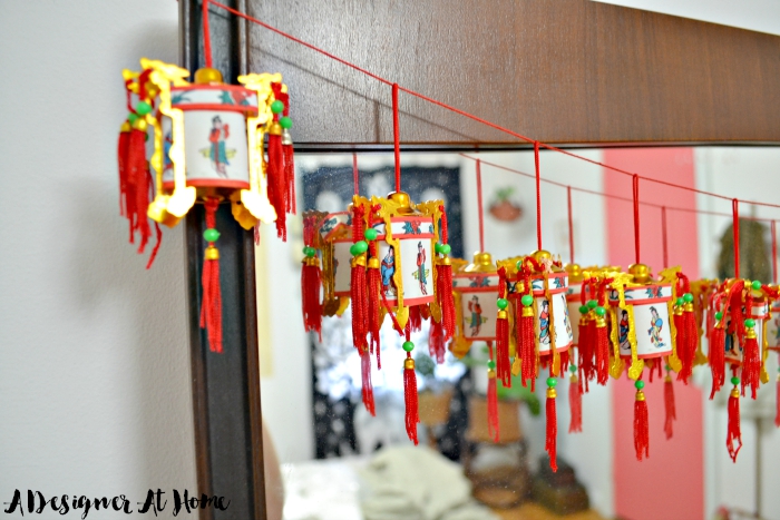 boho-eclectic-mid-century-bedroom-dresser-mirror-garland-chinese-palace-lantern-red-lucky