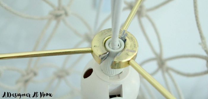 use a dremel tool to cut out a section from the lamp ring to slide it onto the lamp cord or wire your own cord to fit through the opening