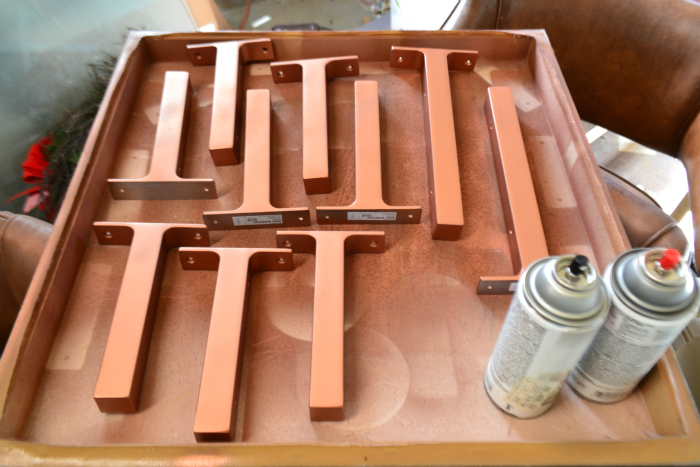 I spray painted IKEA shelf brackets with Ace Hardware's brand copper spray paint- it's my favorite copper spray paint for it's finish and color.