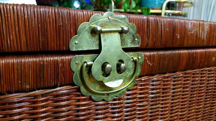 ornate brass hardware on wicker trunk vintage boho style