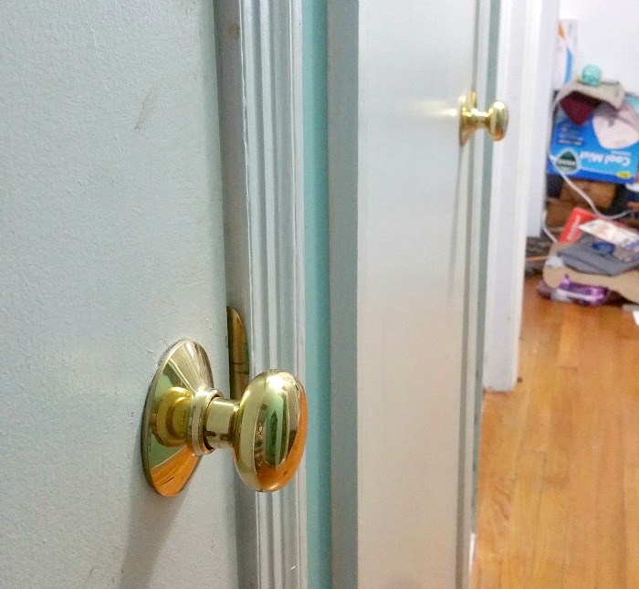 ugly hallway full of polished brass door knobs