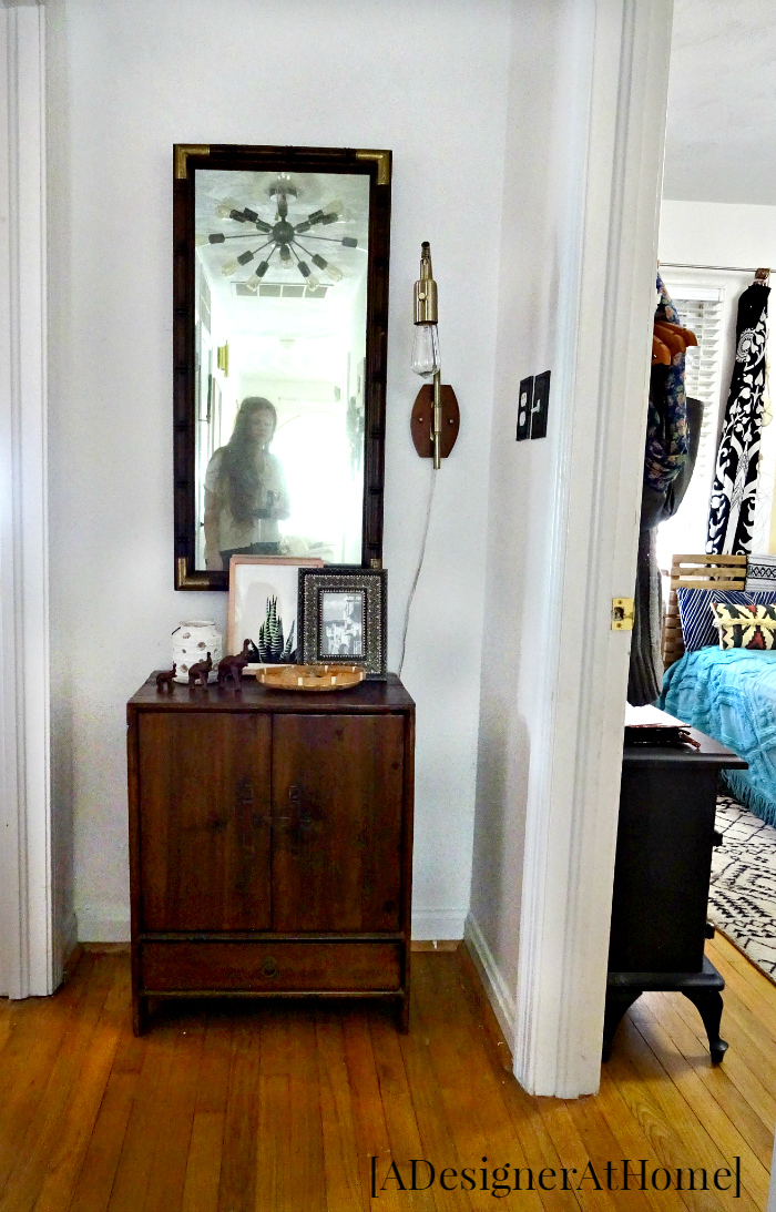 end of hallway peeking into adjacent bedroom