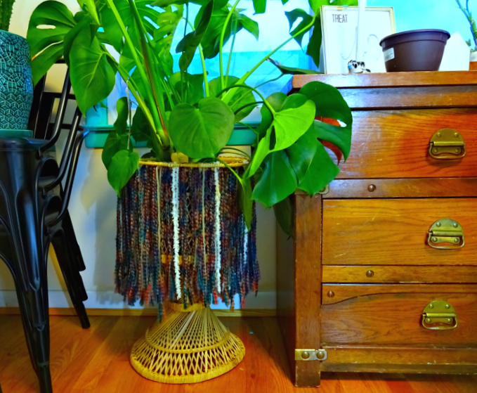 vintage wicker planter boho-ified with yarn fringe skirt
