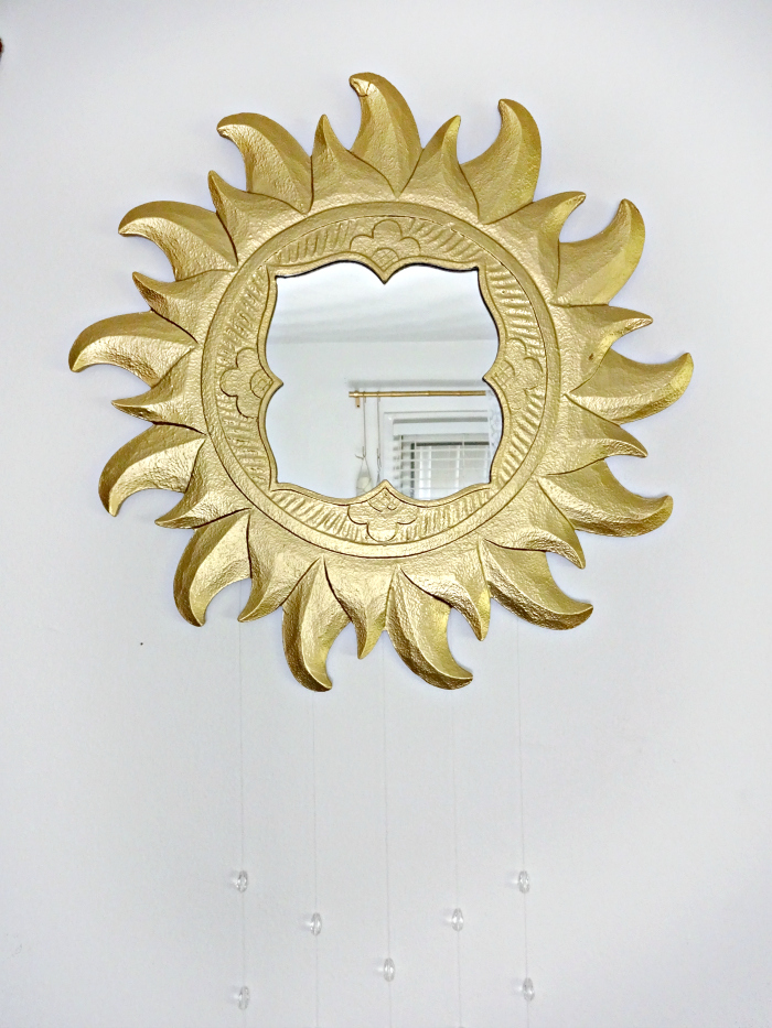 thrifted sun shaped mirror gets a new look with crystals and spray paint- now a SunShower art piece