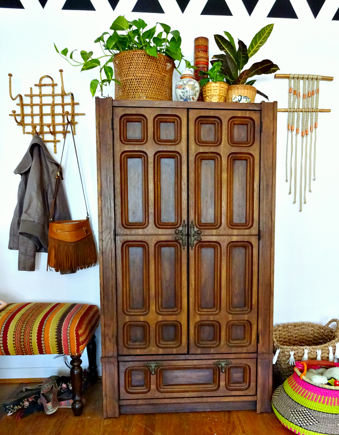 Home office in a cabinet. Ornate wooden cabinet holds craft, DIY and office supplies
