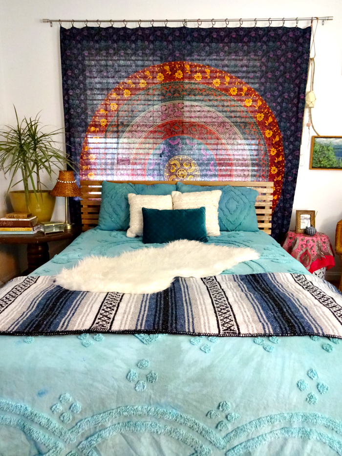 bohemian bedroom with tapestry curtain and headboard, hand dyed bedding, multi textures