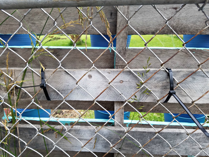 heavy duty zip ties hold pallet to chain link fence