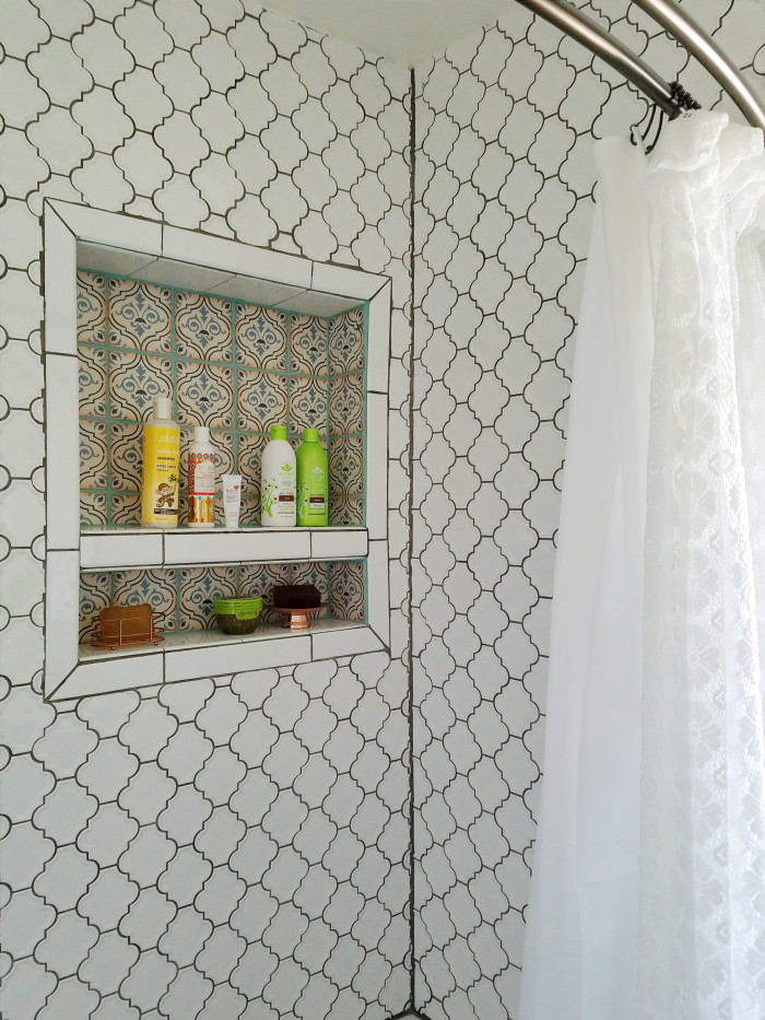 Global inspired bohemian bathroom white tile copper border