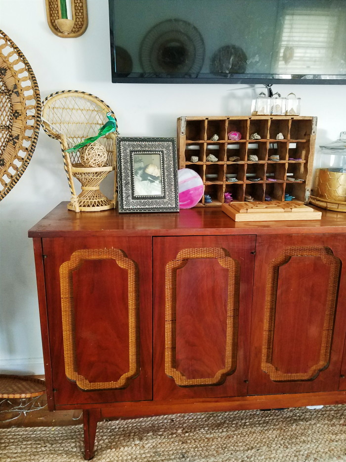 Doll sized wicker peacock chair, bone inlay inspired frame, agate slice collection on soda crate, wooden puzzle