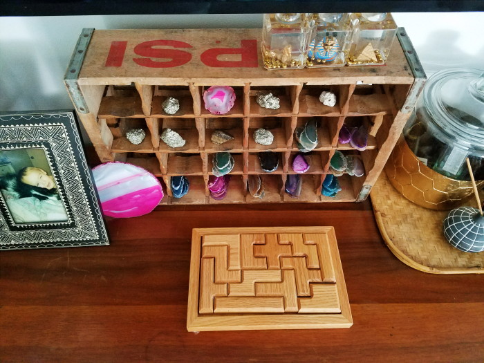Soda crate with rock and agate collection and a wooden puzzle