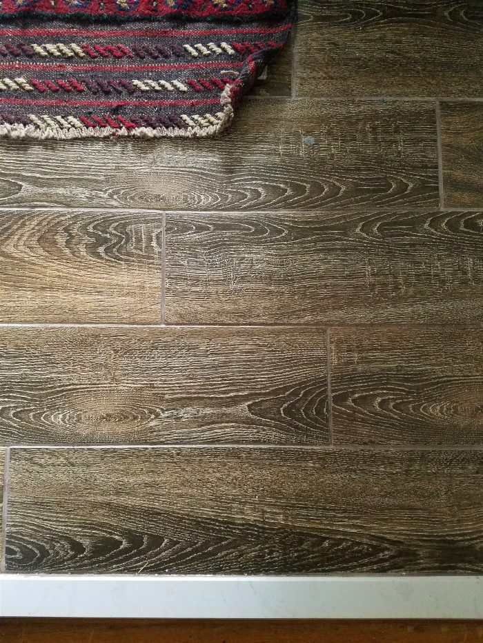 Inexpensive wood look tile with vintage rug