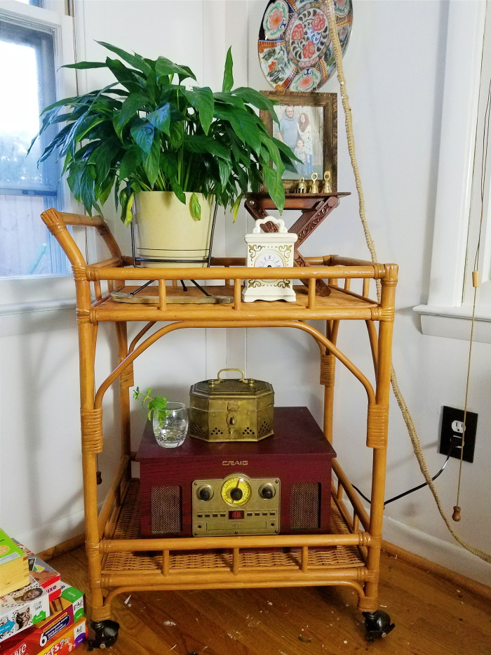Rattan bar cart decorated with vintage bohemian finds