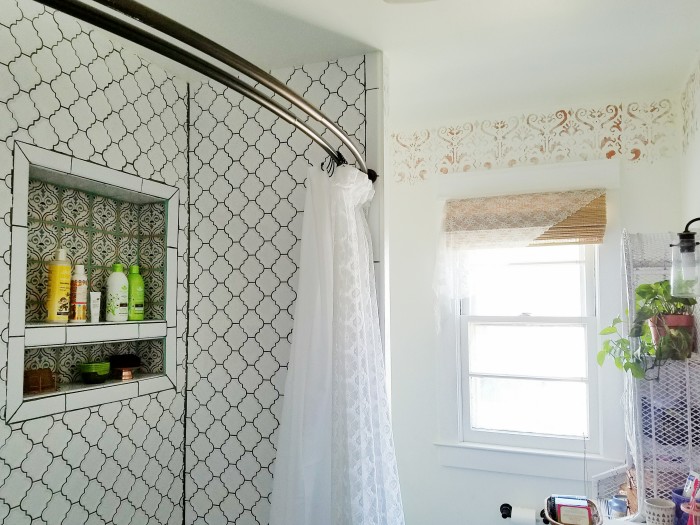 White tile with dark grout and lacey shower curtains