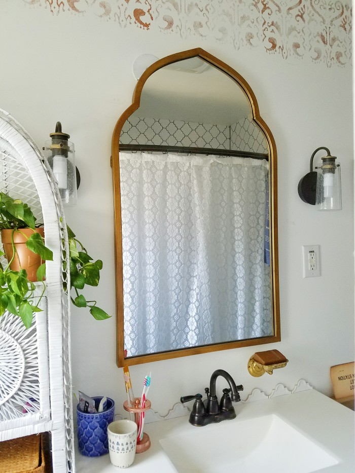 moroccan inspired mirror shape and indian ikat inspired copper wall stencil bathroom design choices