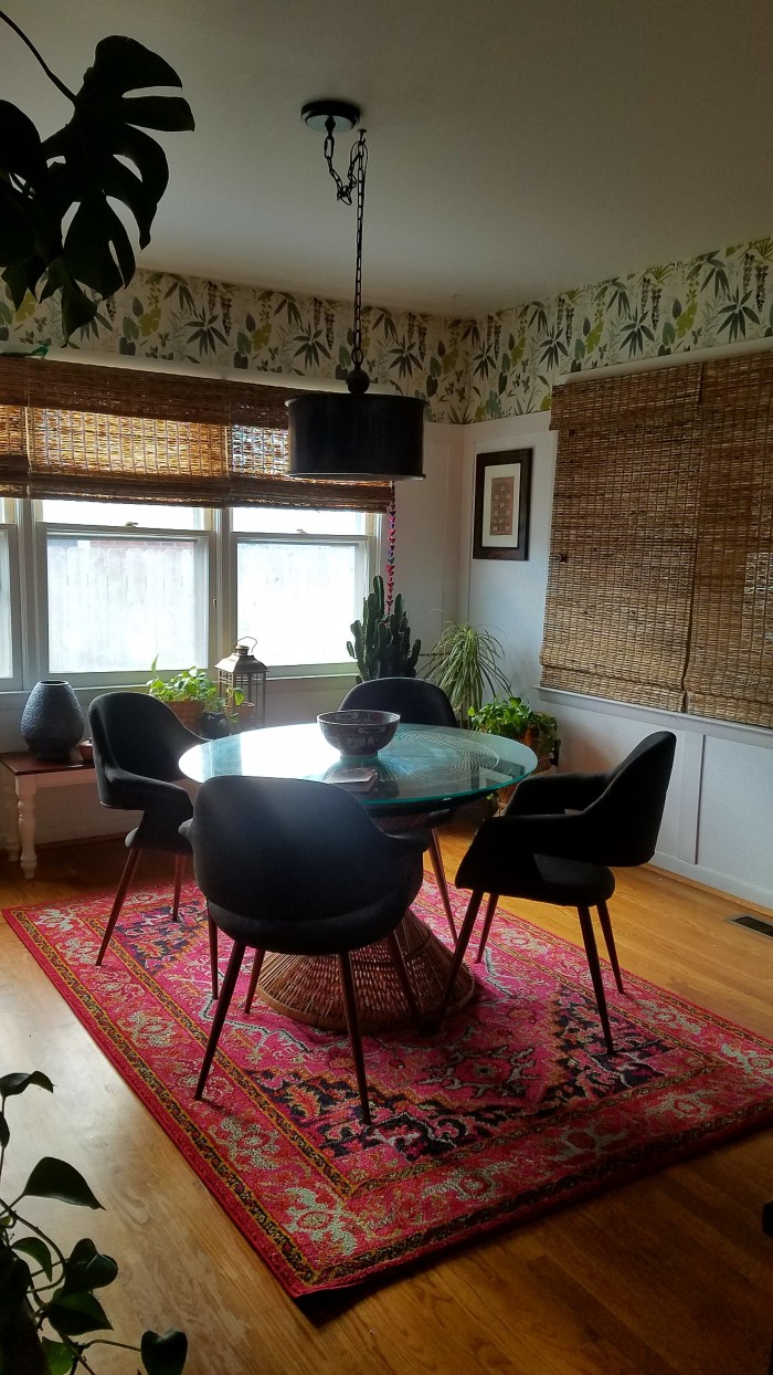 Sunny boho eclectic dining room in pink and green | modern furniture paired with tropical wicker