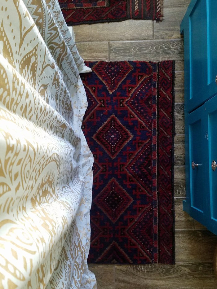 Cutting a vintage rug into bath rug shapes for a unique one of a kind boho look