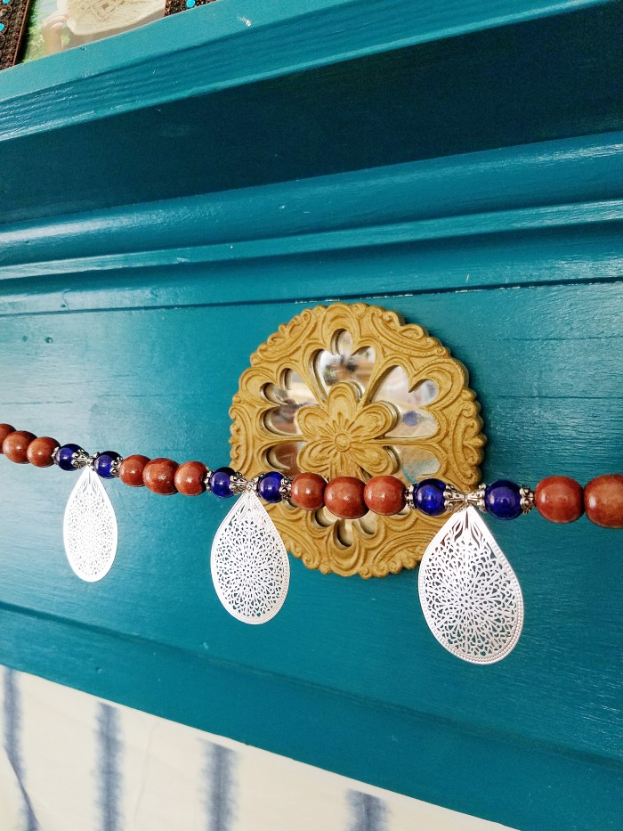 Blue fireplace bohemian mantle with thrifted pottery DIY wood bead garland rattan and crystal accents