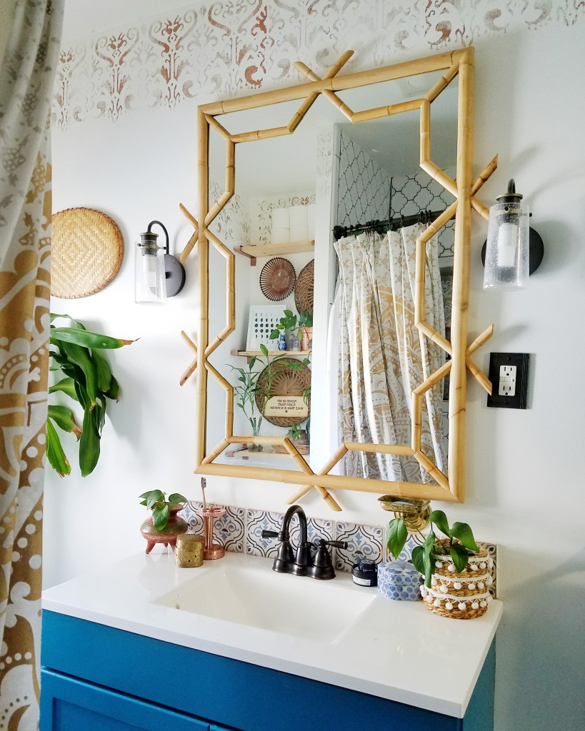 Global boho bathroom, rattan mirror, blue vanity