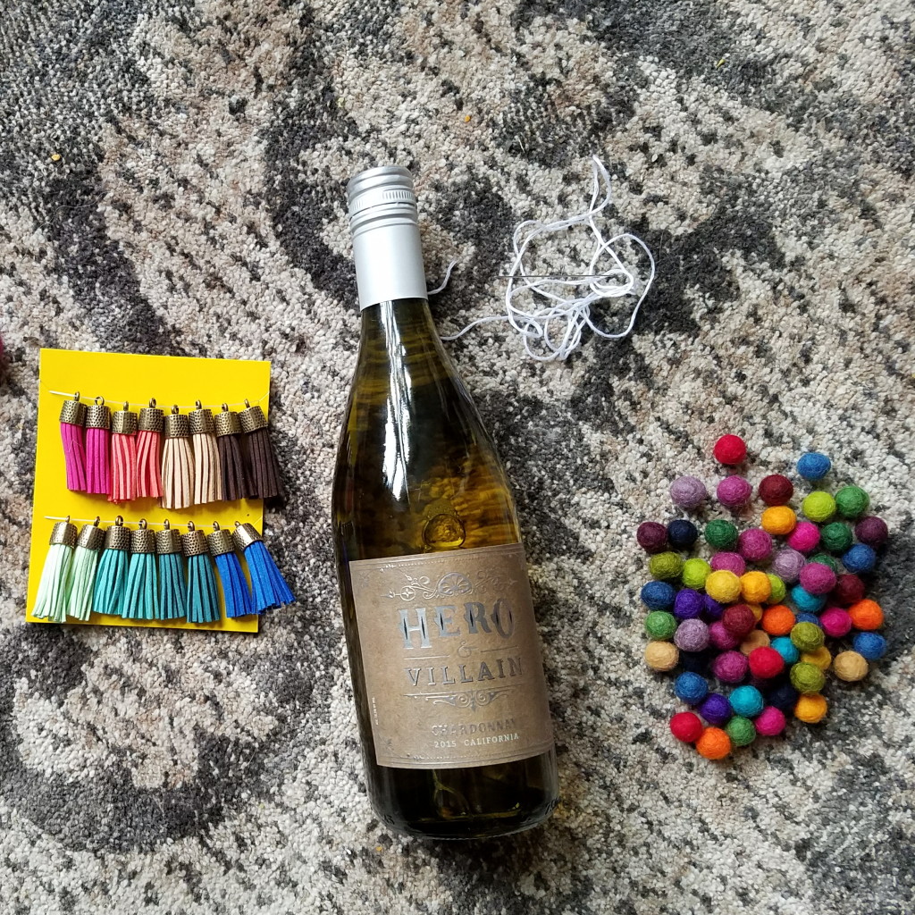 Supplies: tassels, bottled drink, felt balls, embroidery thread and needle