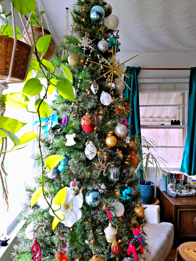 Global Boho Christmas Tree incorporates bright pops of color with whimsical mushroom, bird and flower ornaments