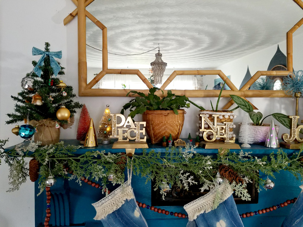 colorful-eclectic-christmas-mantel-decorated-with-live-houseplants