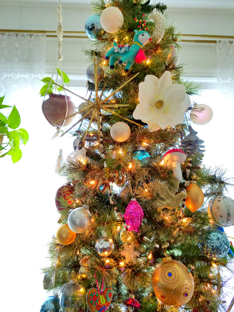 Global Boho Christmas Tree incorporates bright pops of color with whimsical mushroom, bird and flower ornaments