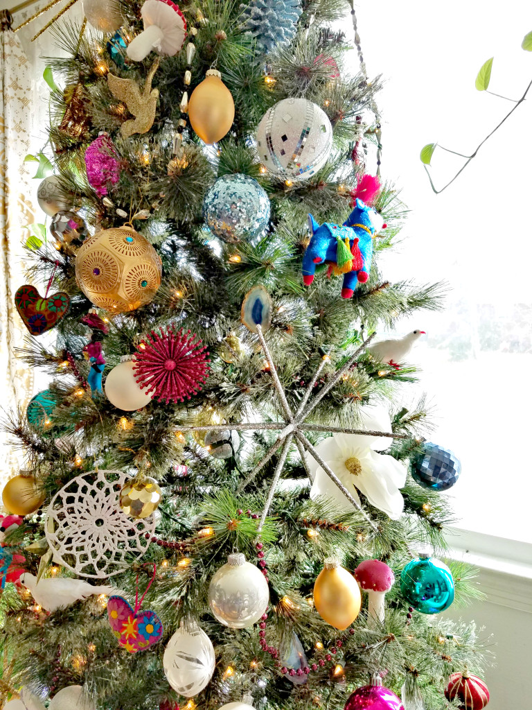 Global Boho Christmas Tree incorporates bright pops of color with whimsical mushroom, bird and flower ornaments