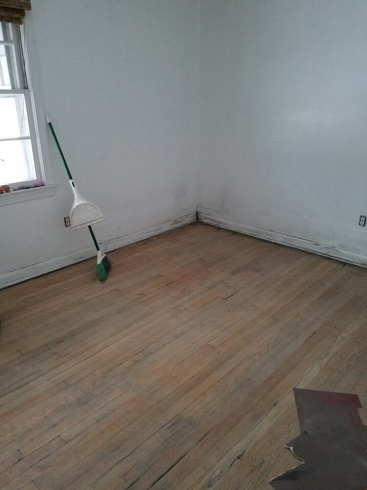 in progress sanding black stain from pine floors