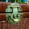 ornate brass hardware on wicker trunk vintage boho style