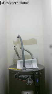 rheem hot water heater tucked into right side of underutilized pantry