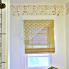 layered window treatments with a copper indian stencil border