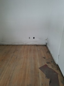 in progress sanding black stain from pine floors